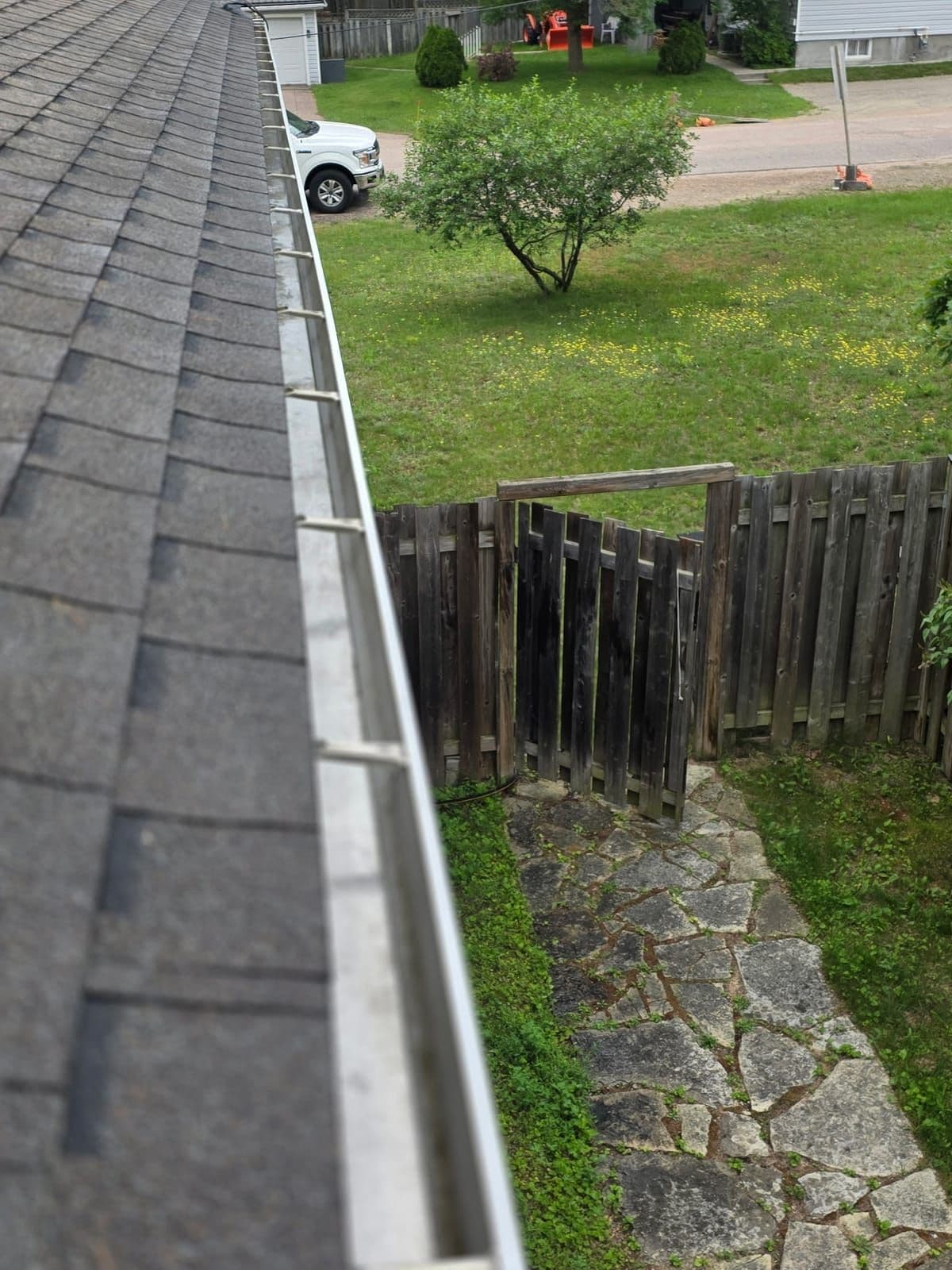 Spotless residential gutter and downspout flowing freely after a PVS gutter cleaning in the Ottawa Valley