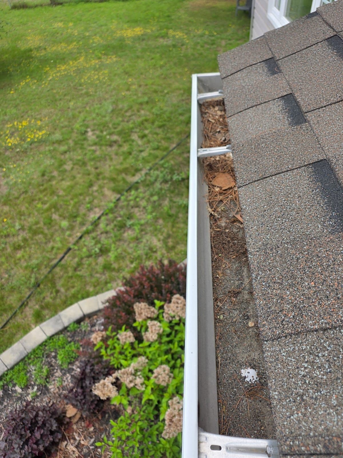 Long residential gutter run cleared of leaves and debris in Petawawa