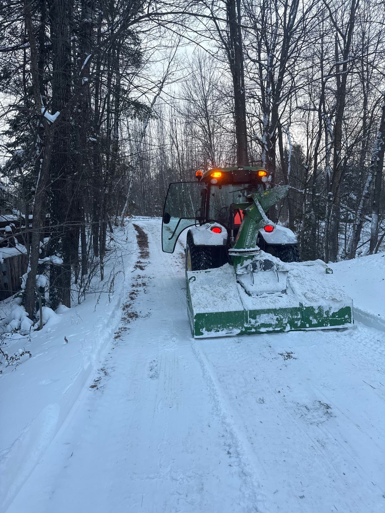 PVS tractor with snowblower clearing a residential driveway in the Ottawa Valley