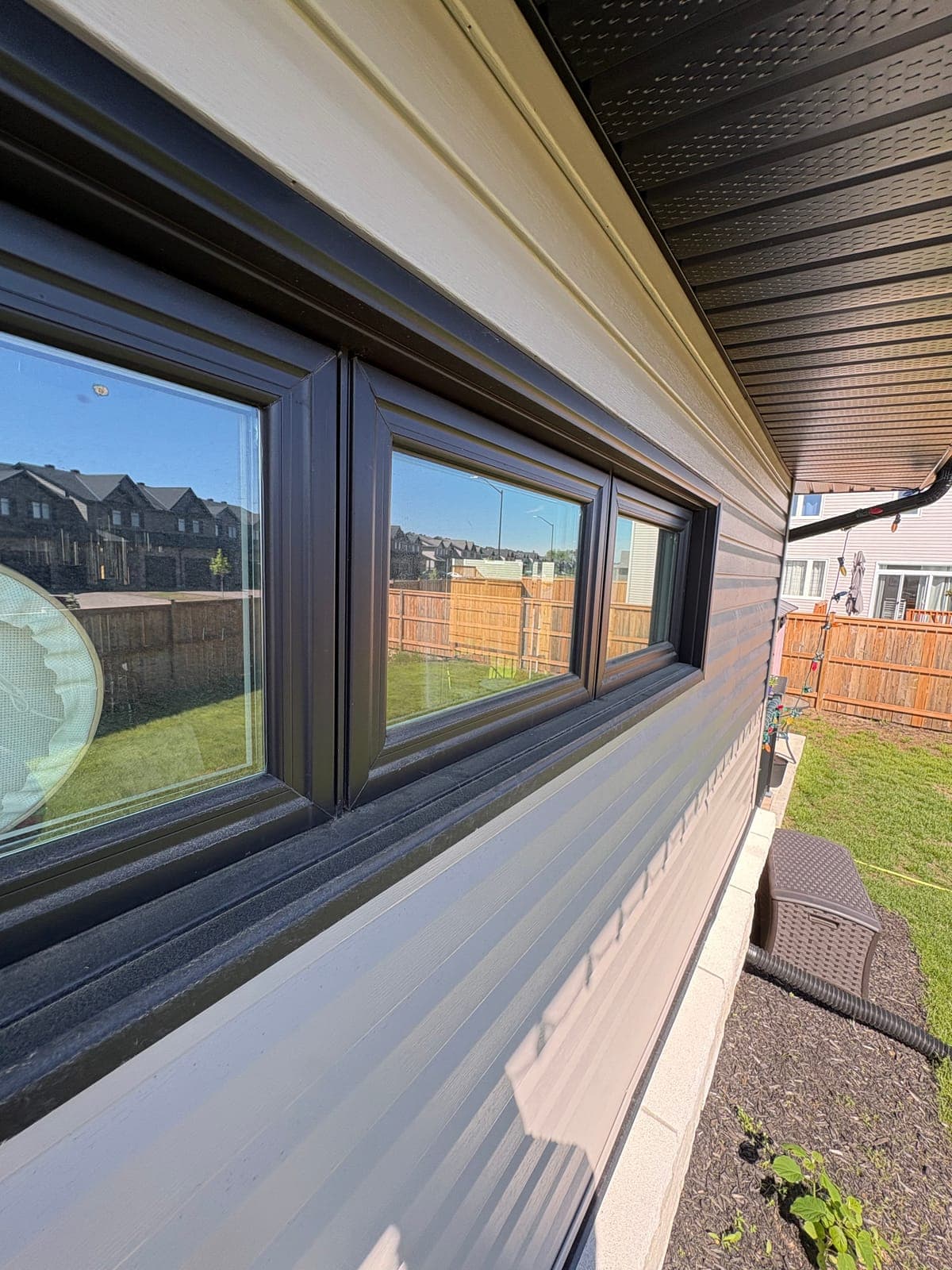 Residential window with water staining and film before professional window cleaning in the Ottawa Valley