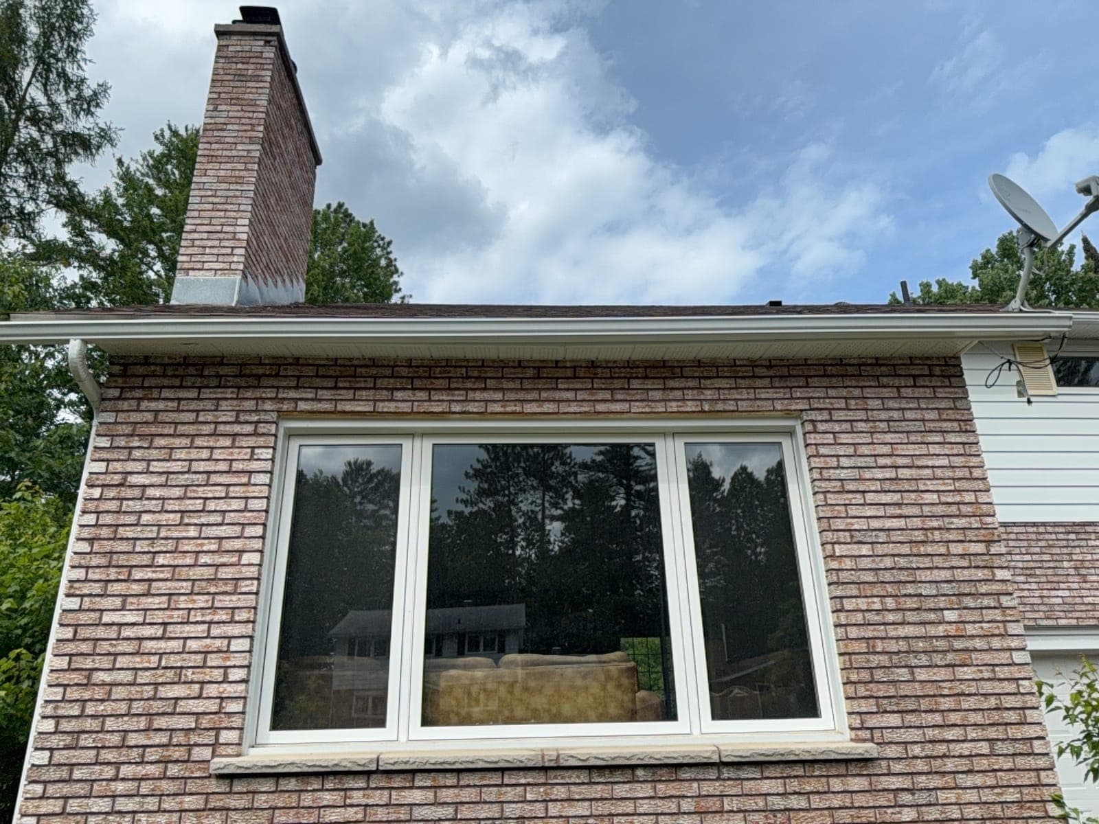 Brick residential home with large bay window cleaned by PVS