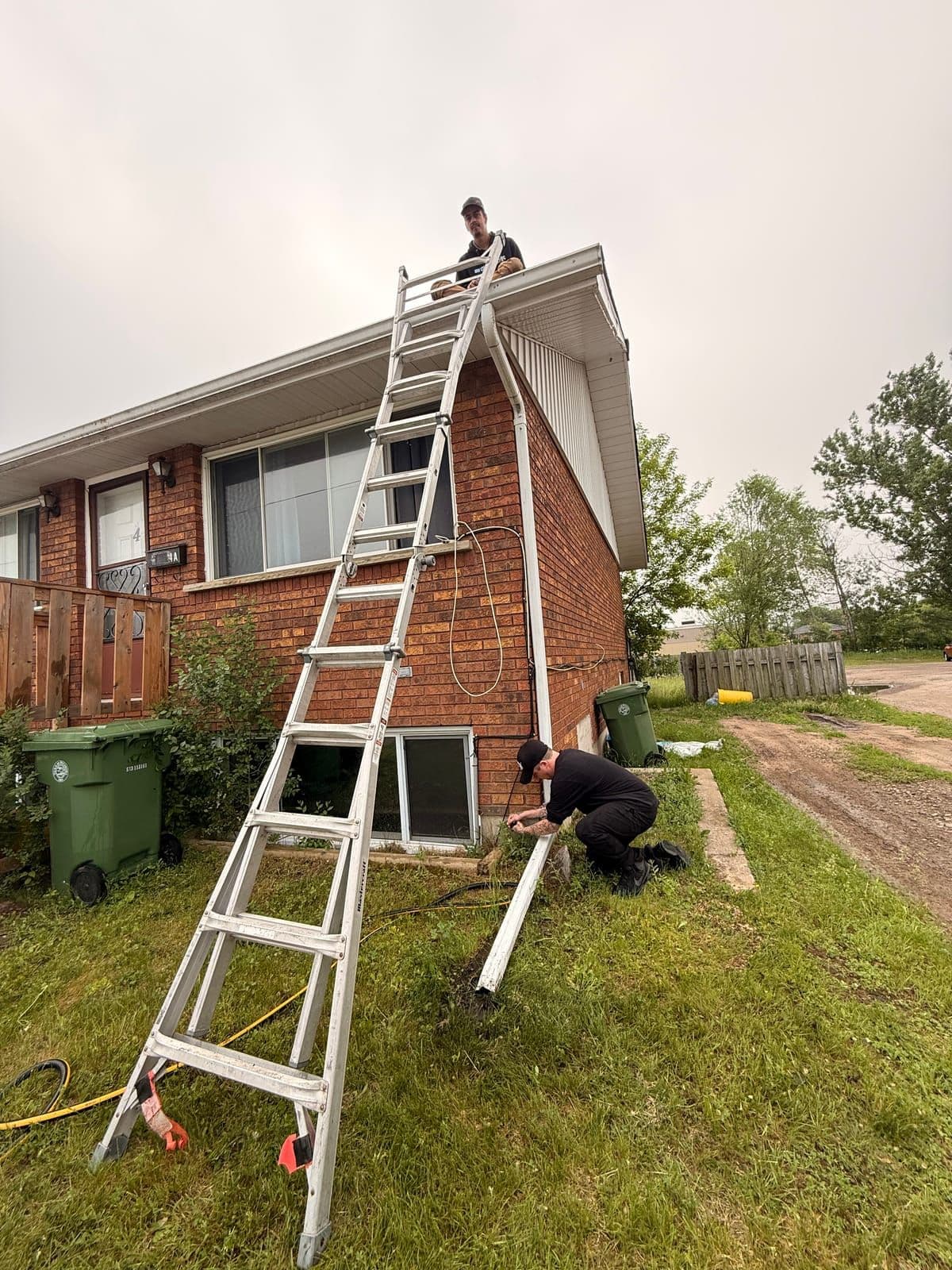 Prestige View Services crew on ladders clearing residential gutters in Petawawa