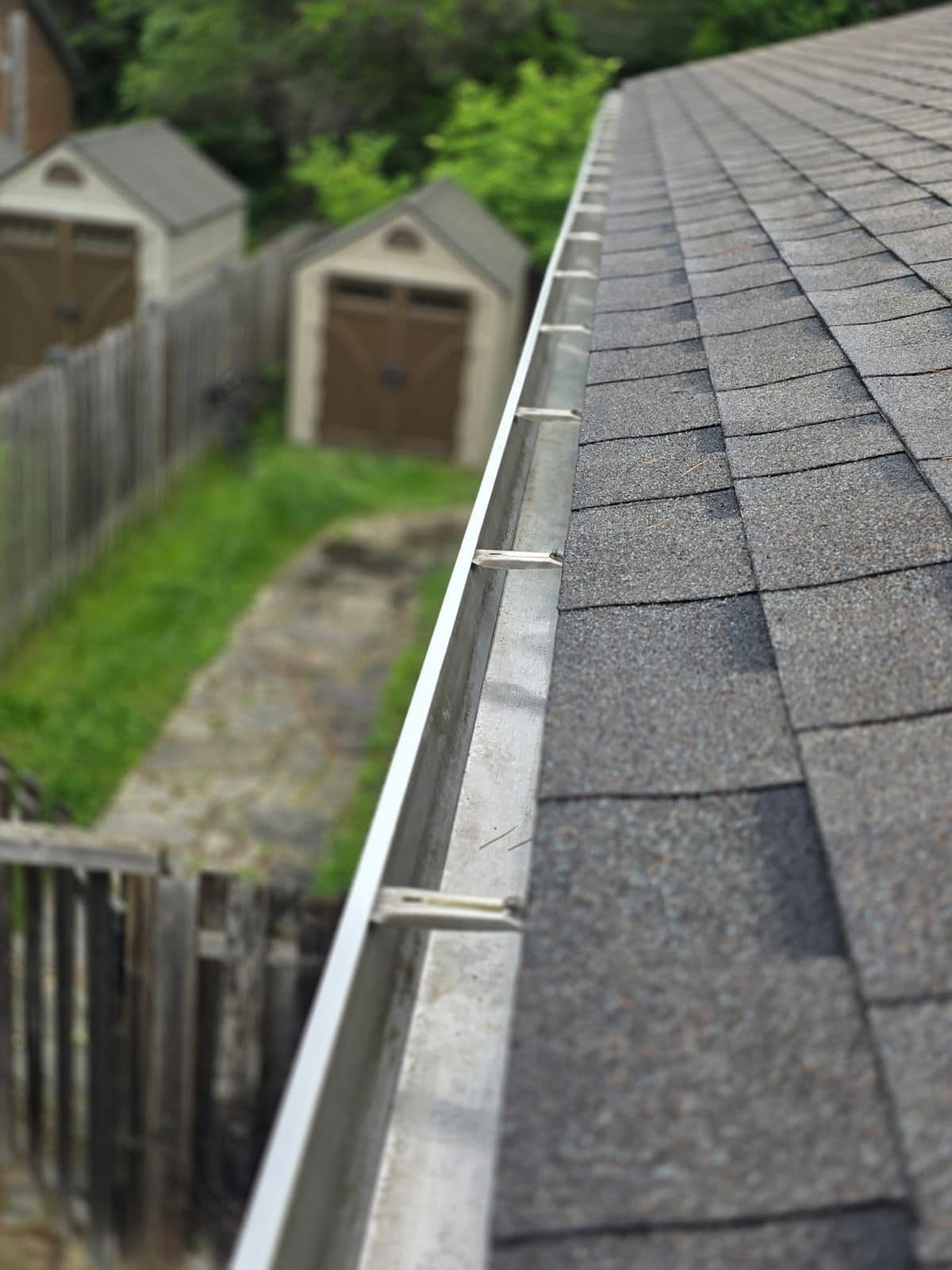 Residential gutter packed with leaves and shingle grit before a Prestige View Services gutter cleaning in the Ottawa Valley