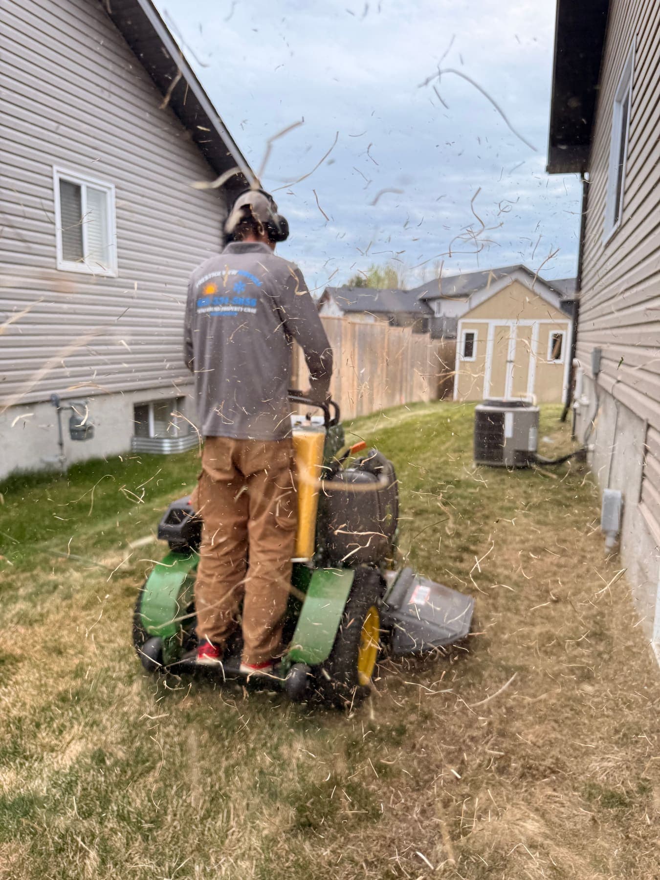 PVS lawn care crew mowing a residential lawn, Ottawa Valley