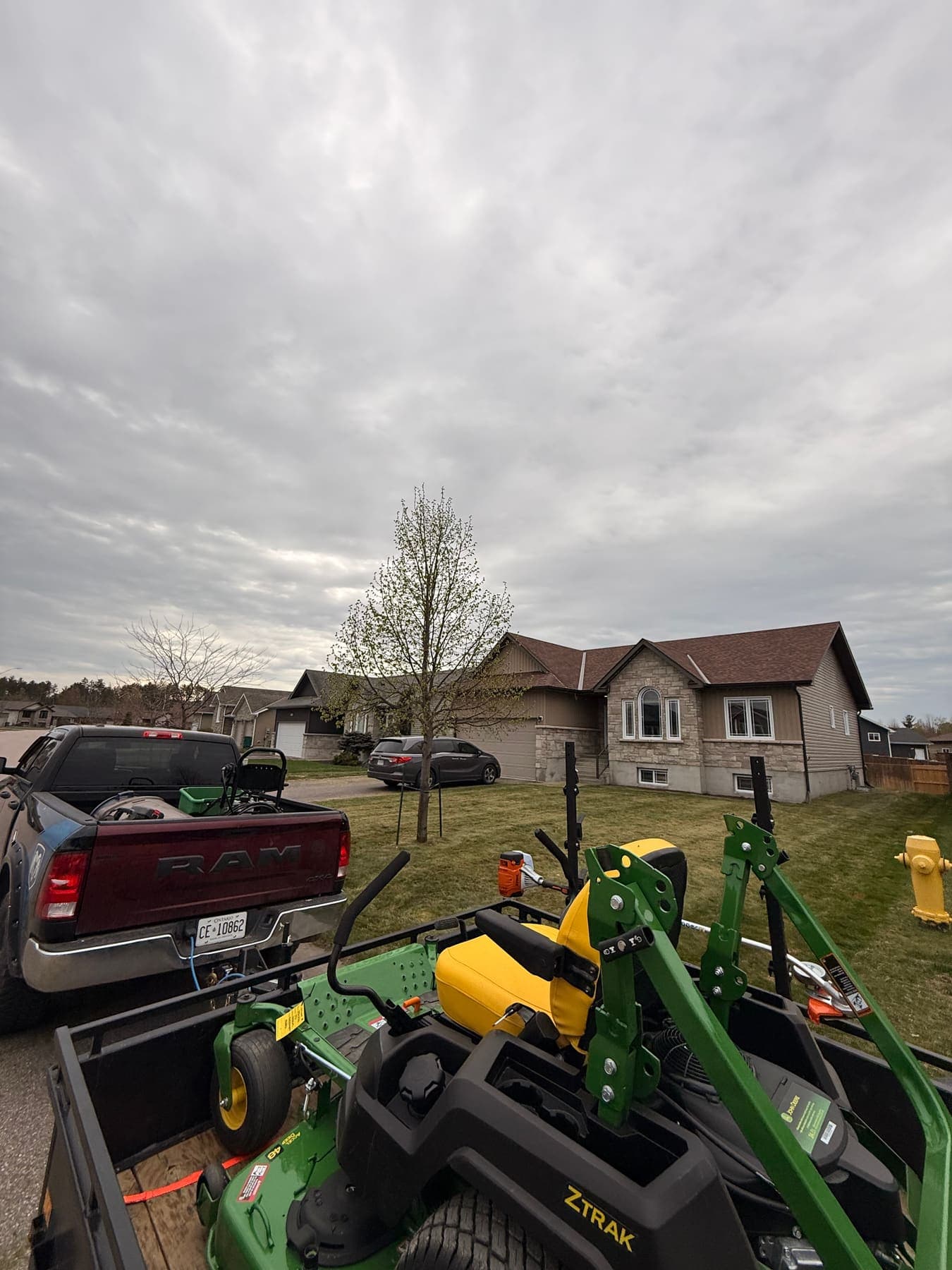 PVS lawn care crew mowing a residential lawn, Ottawa Valley