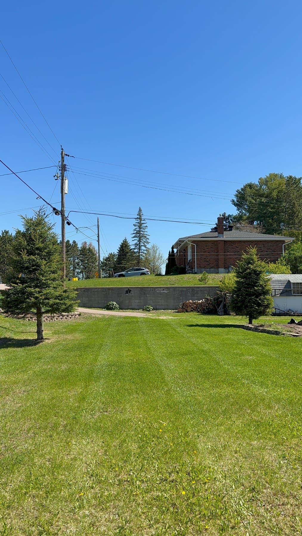 PVS lawn care crew mowing a residential lawn, Ottawa Valley