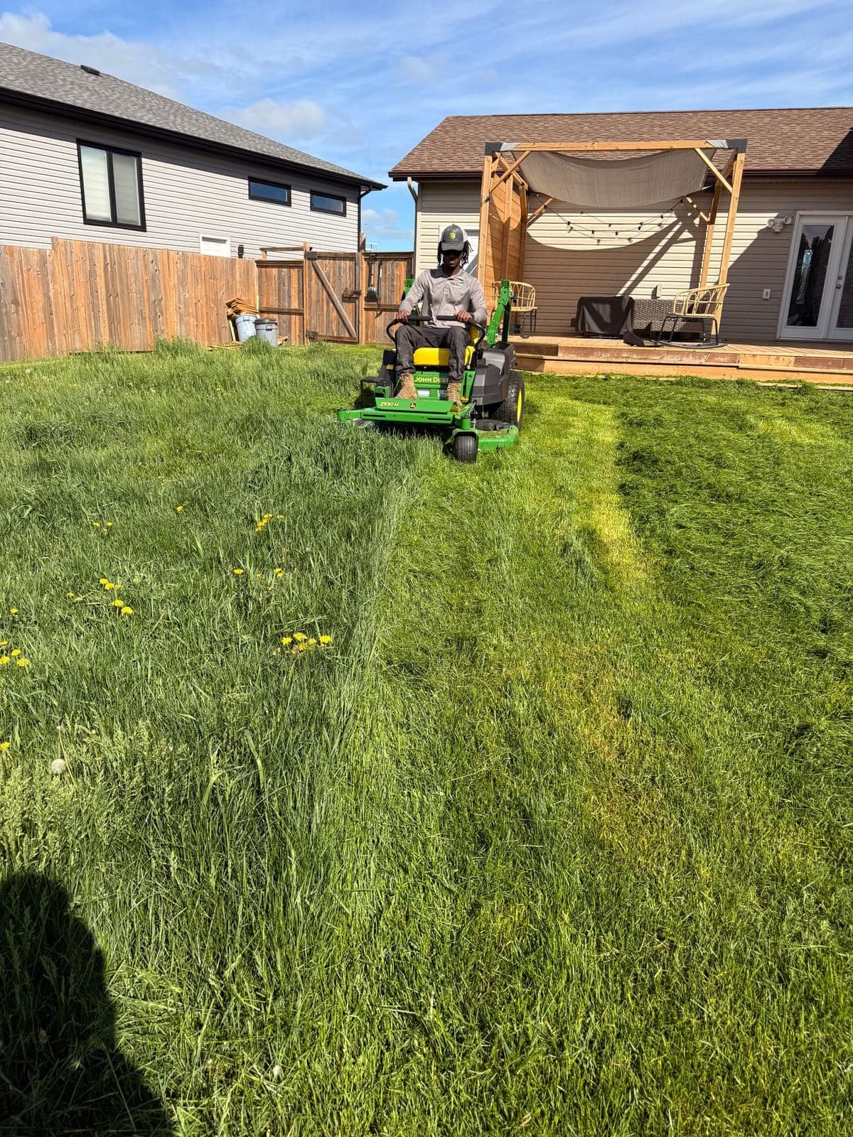 PVS lawn care crew mowing a residential lawn, Ottawa Valley