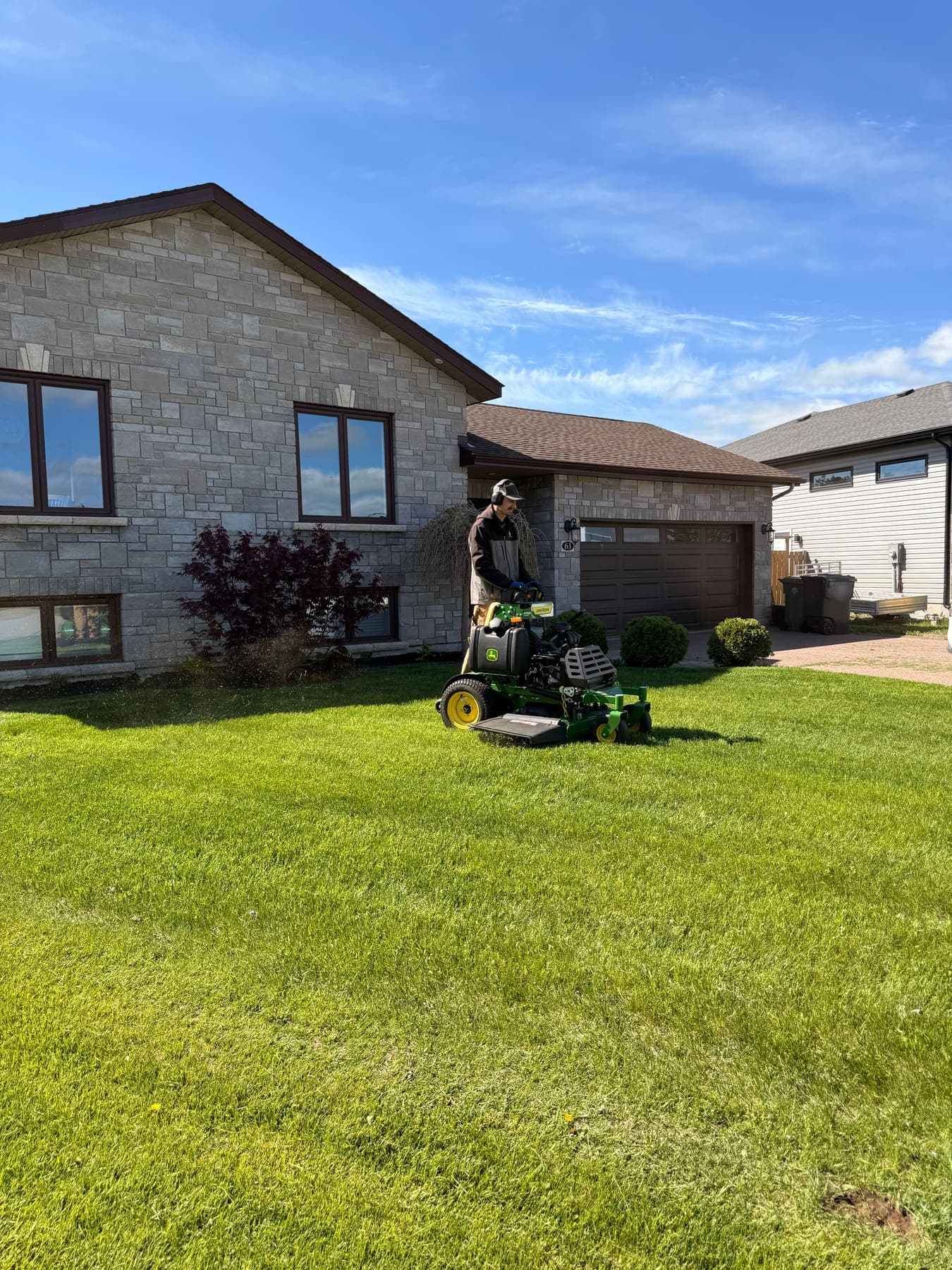 PVS lawn care crew mowing a residential lawn, Ottawa Valley
