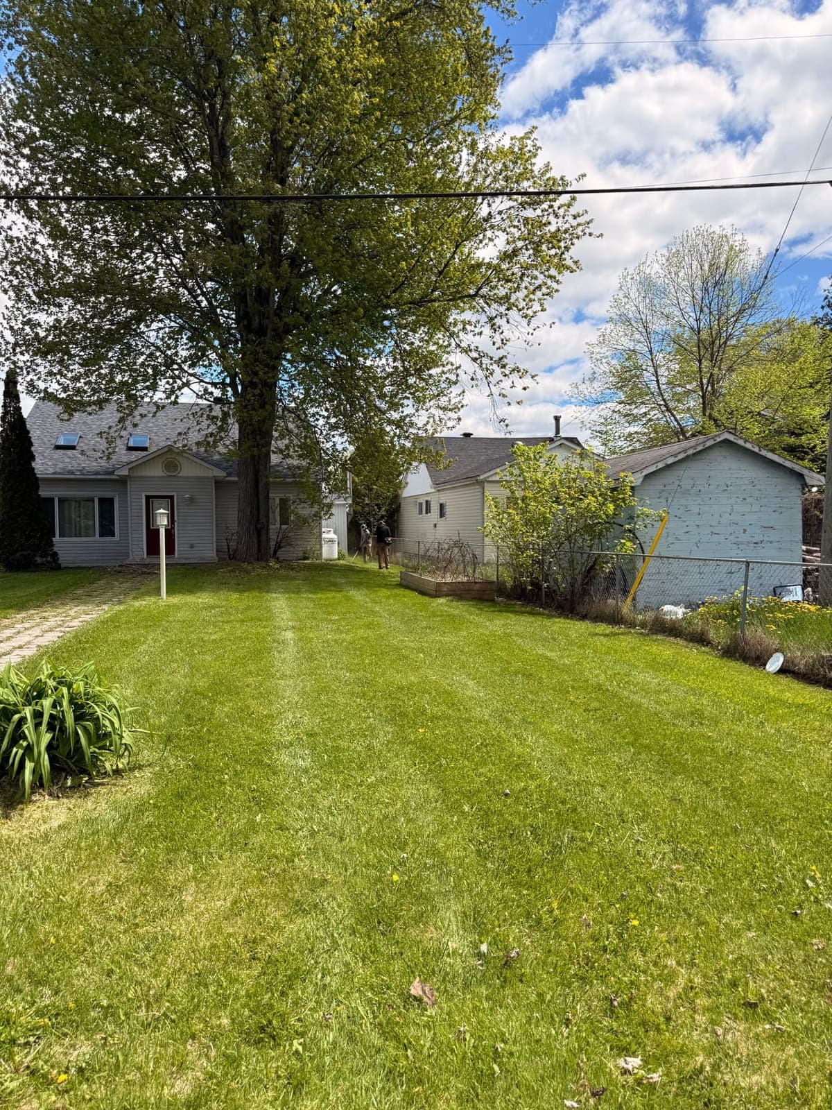 PVS lawn care crew mowing a residential lawn, Ottawa Valley
