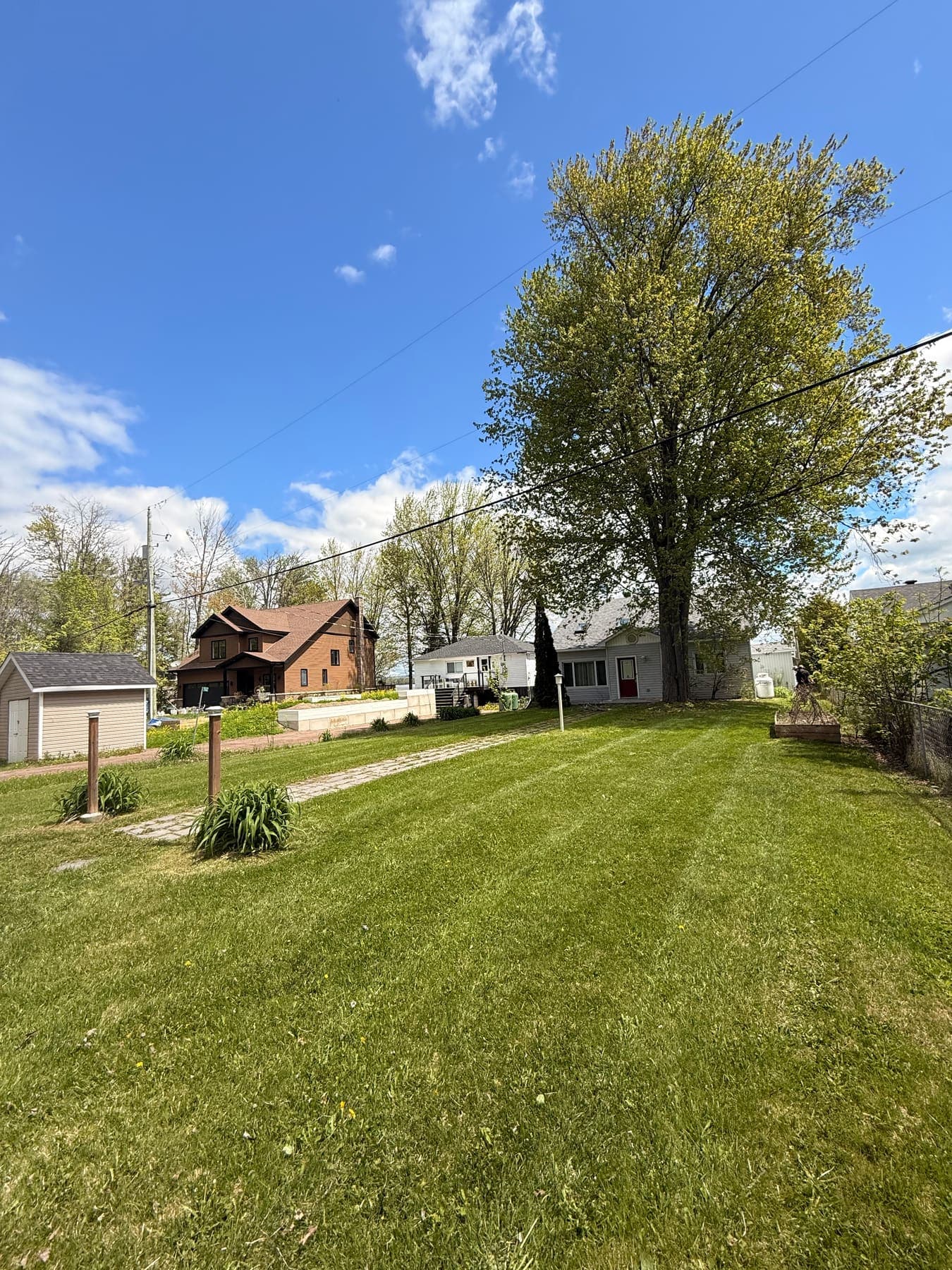PVS lawn care crew mowing a residential lawn, Ottawa Valley