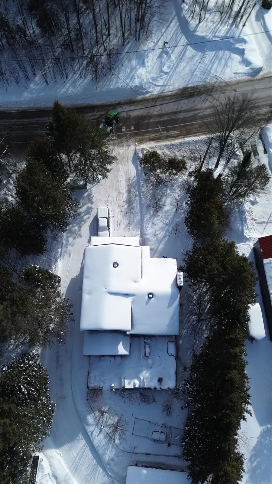 Aerial view of a tractor plowing a snowbound residential street in the Ottawa Valley