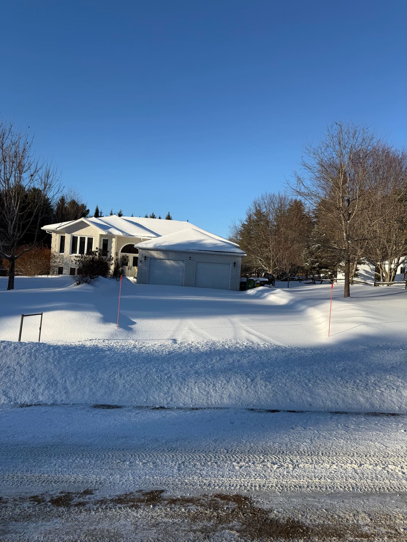 PVS snow removal crew clearing a property after a snowfall, Ottawa Valley