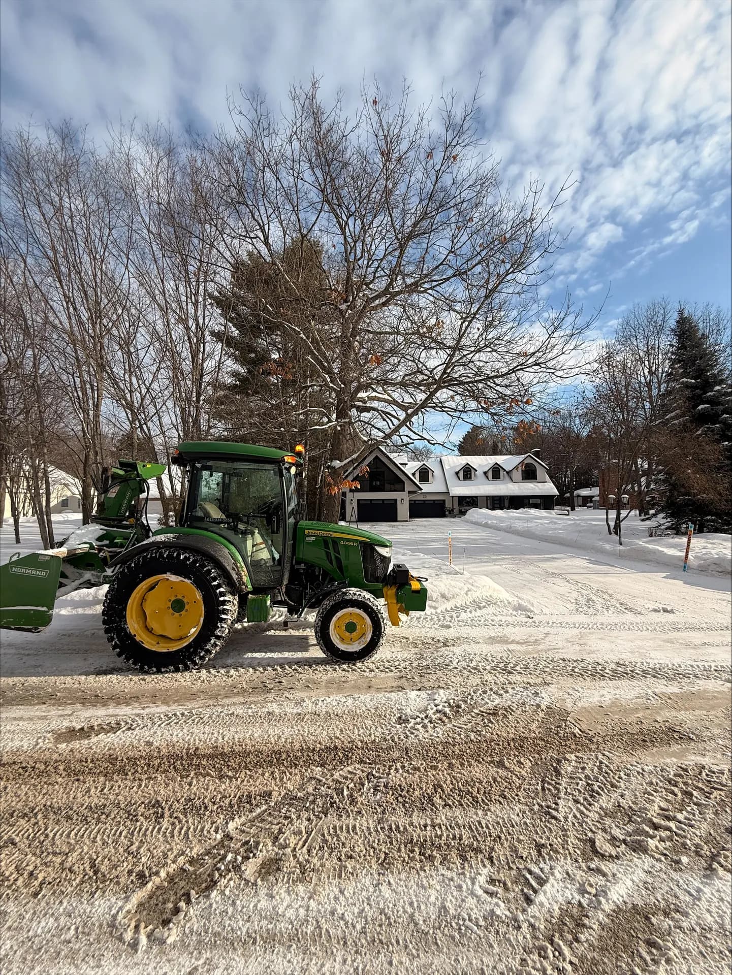PVS tractor beside a freshly cleared estate driveway on a sunny winter day near Pembroke