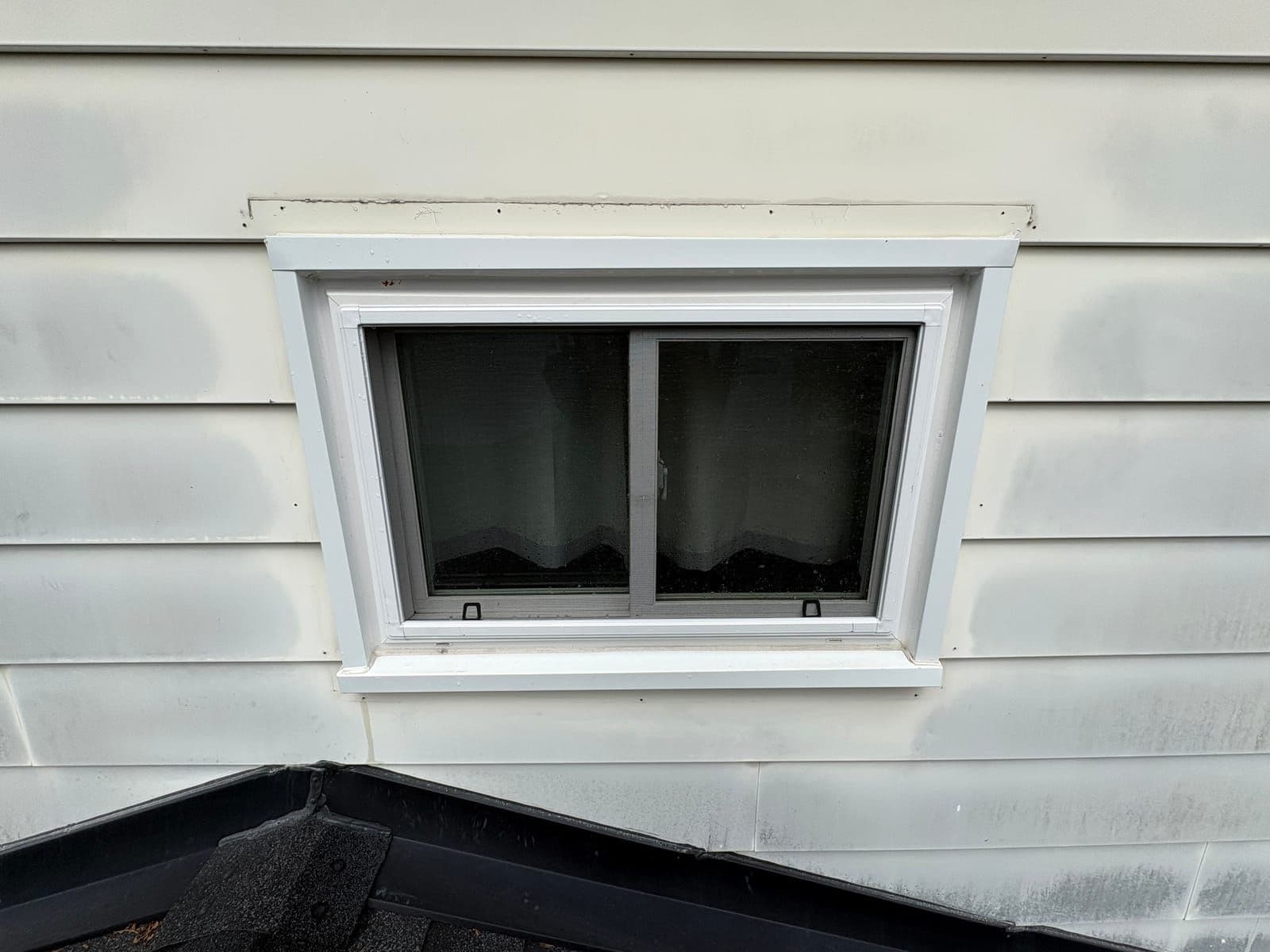 Crisp dormer window on white siding after residential window cleaning in Petawawa