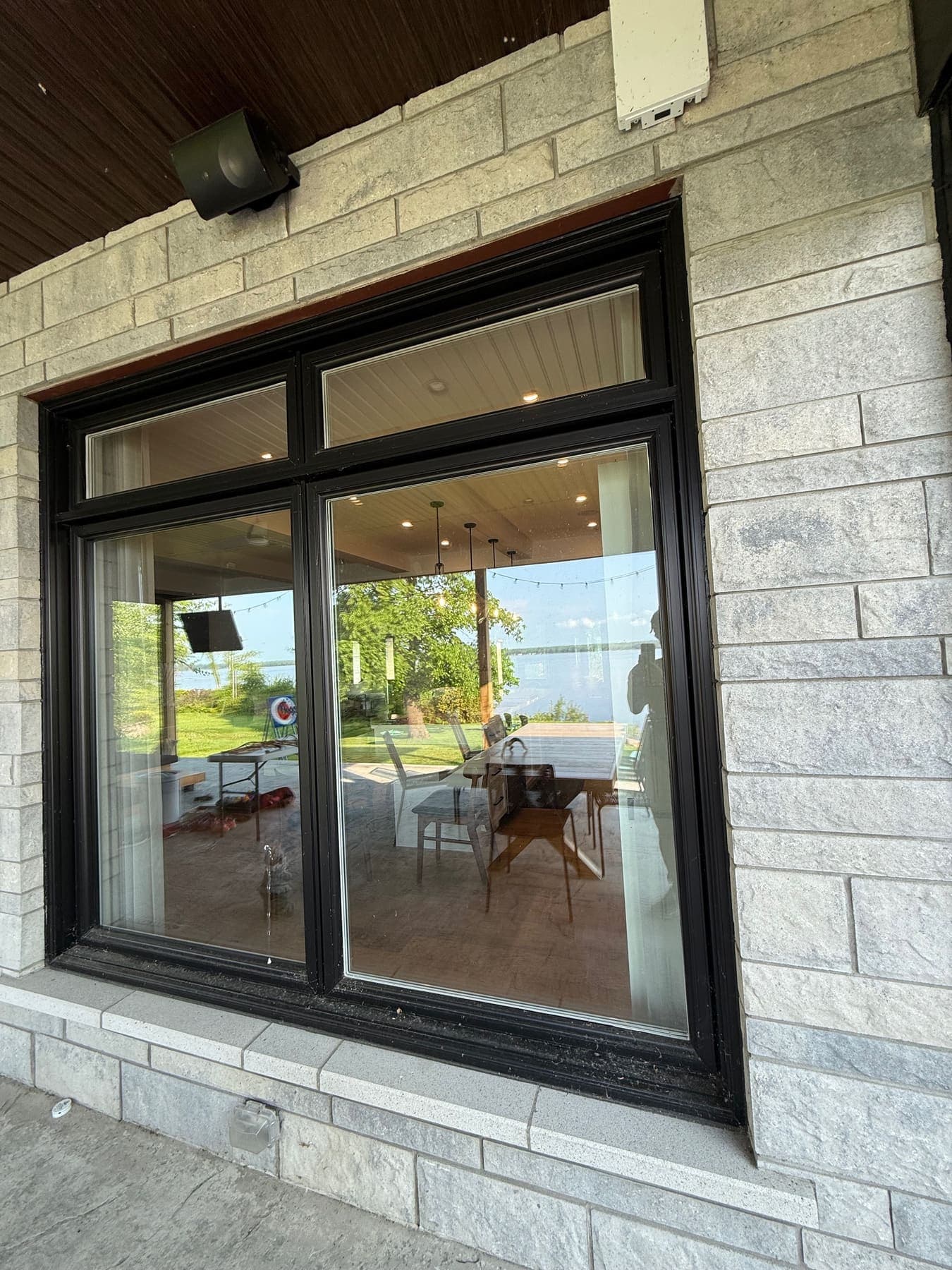 Streak-free residential window on a stone exterior with patio view